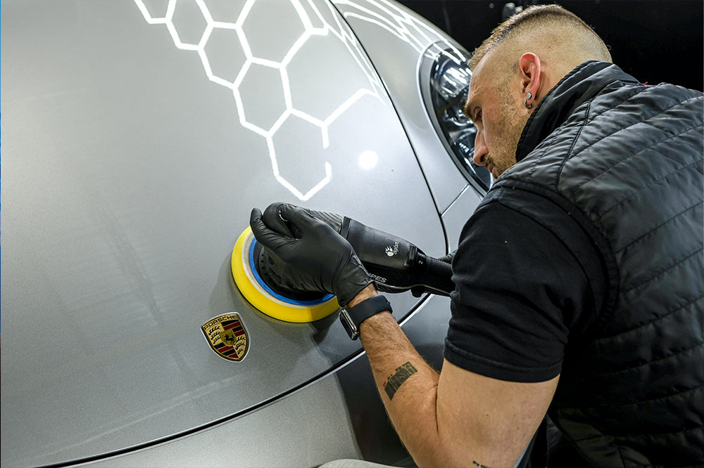 Porsche paint correction under inspection lighting