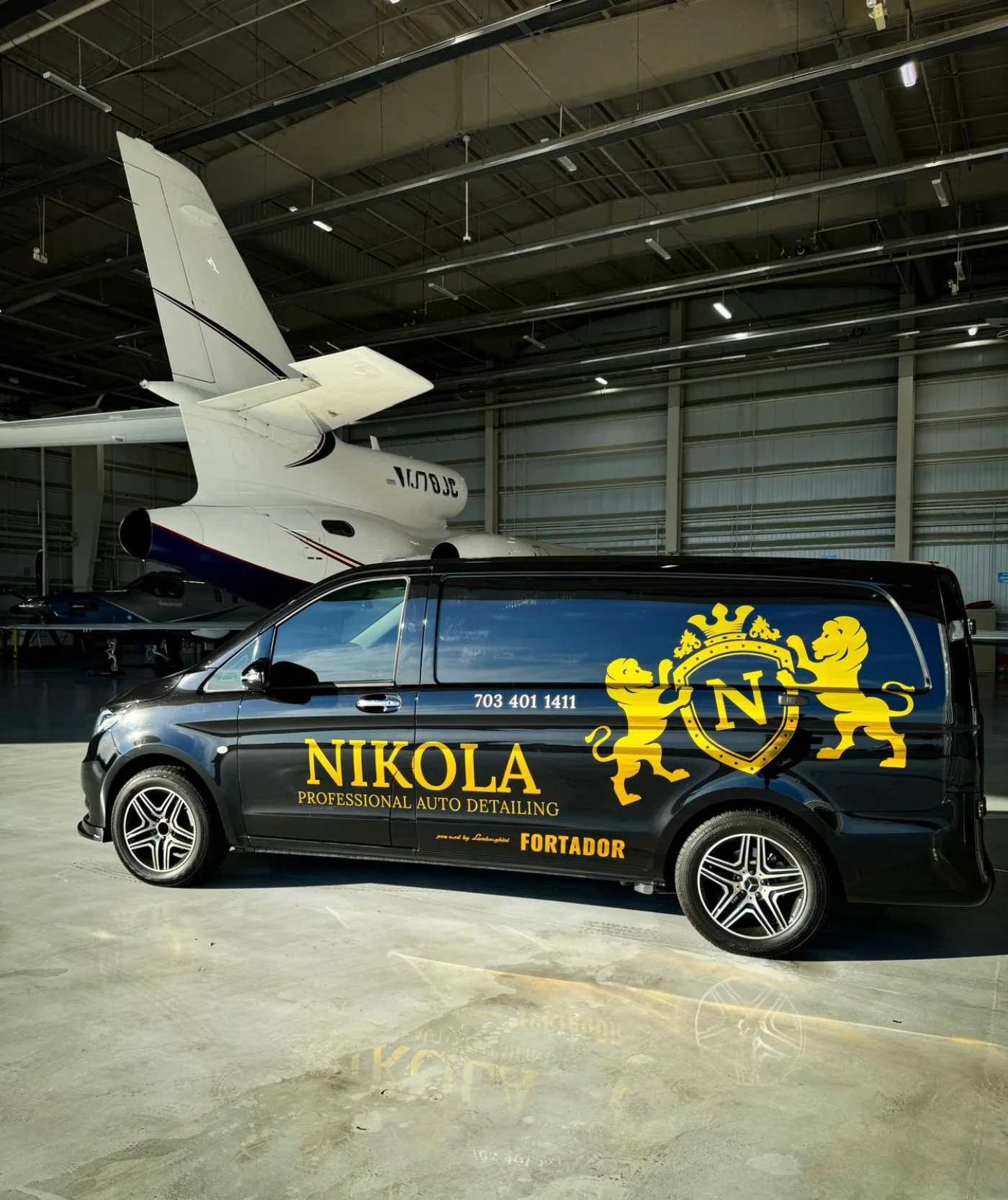 Nikola mobile detailing van beside a private aircraft in a Northern Virginia hangar