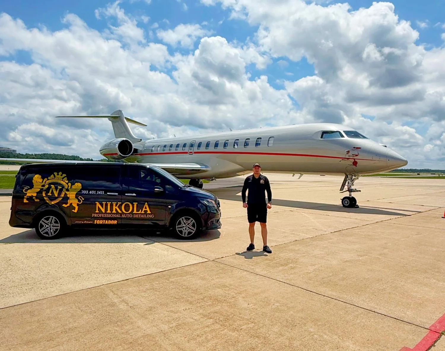 Nikola beside the branded mobile detailing unit and a private aircraft
